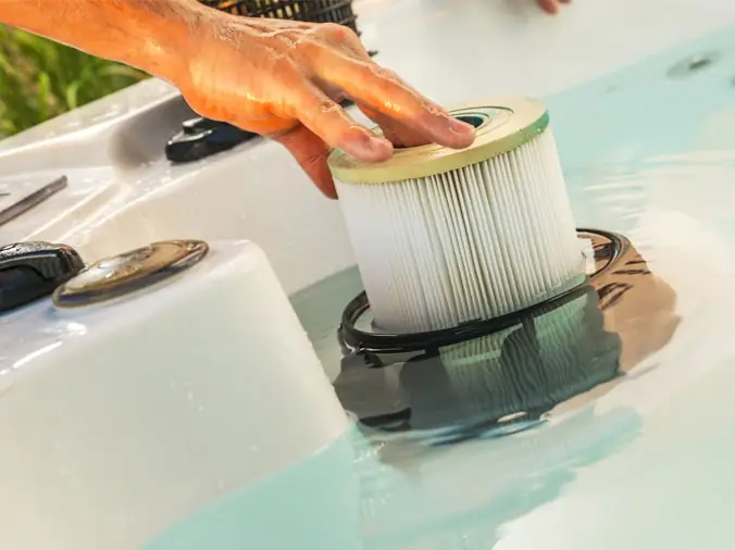 IMage or circular pool filter cartridge being changed